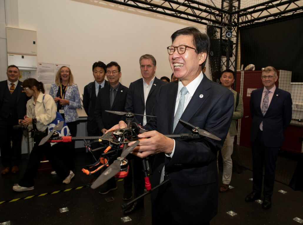 Mayor of Busan Park Heong-Joon holds a drone at the University of Liverpool's Digital Innovation Facility