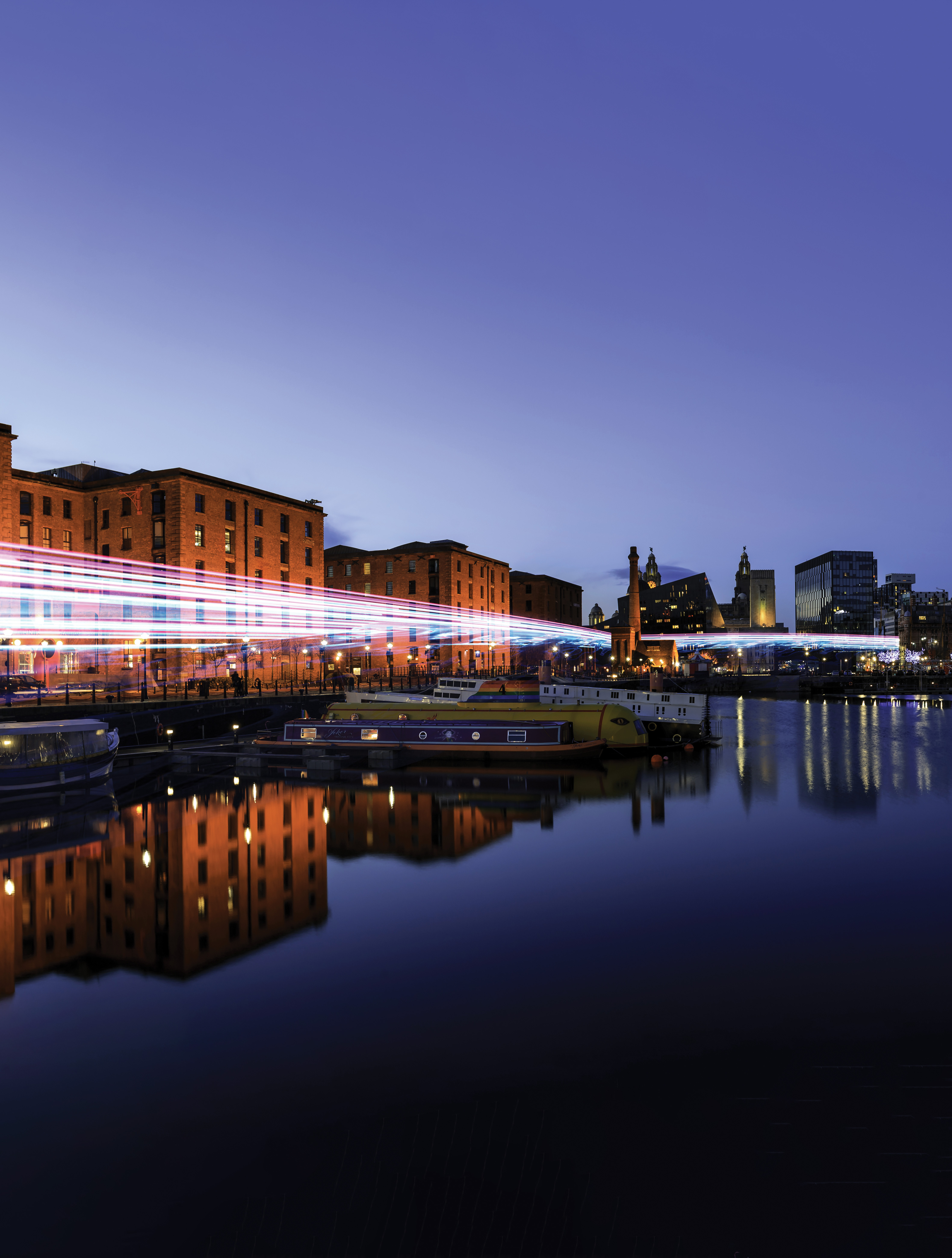 panoramic view of Liverpool skyline reflected in river mersy at albert dock