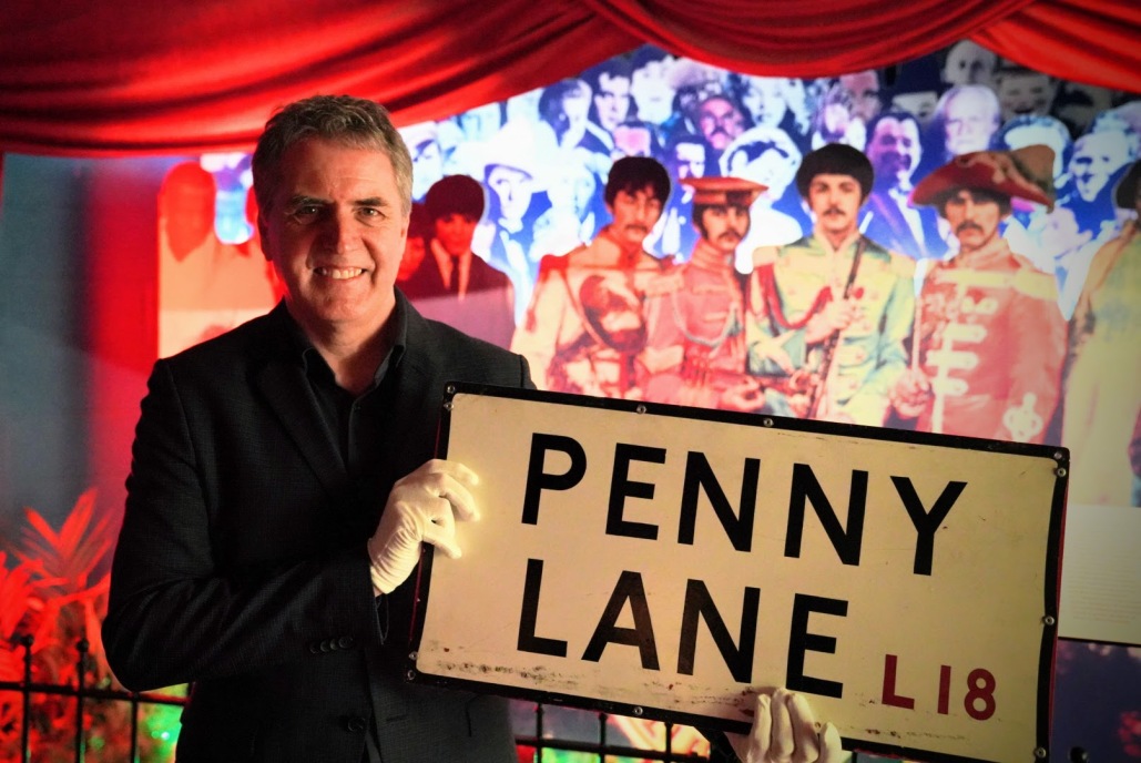 Mayor Steve Rotheram holding the returned Penny Lane street sign 