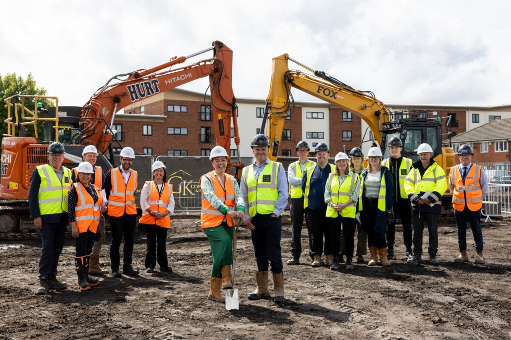 Officials breaking gound at ceremony at construction site.