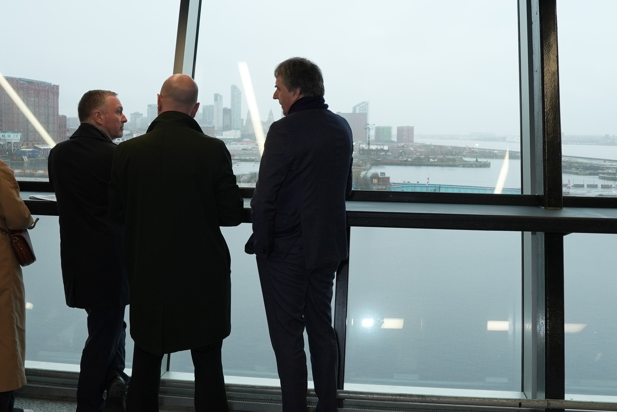 Steve Reed, Secretary of State for Housing, Communities and Local Government, Liverpool City Council Leader Liam Robinson and Mayor Steve Rotheram looking south across Liverpool's North Docks from Everton's Hill Dickinson Stadium