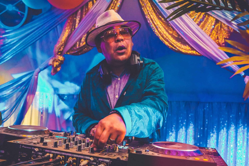 Actor and DJ Craig Charles standing at a DJ turntable