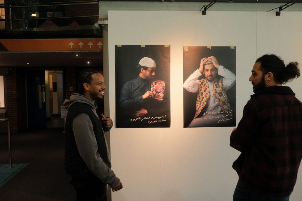 Two people looking at the installation of 'Waiting Rooms'