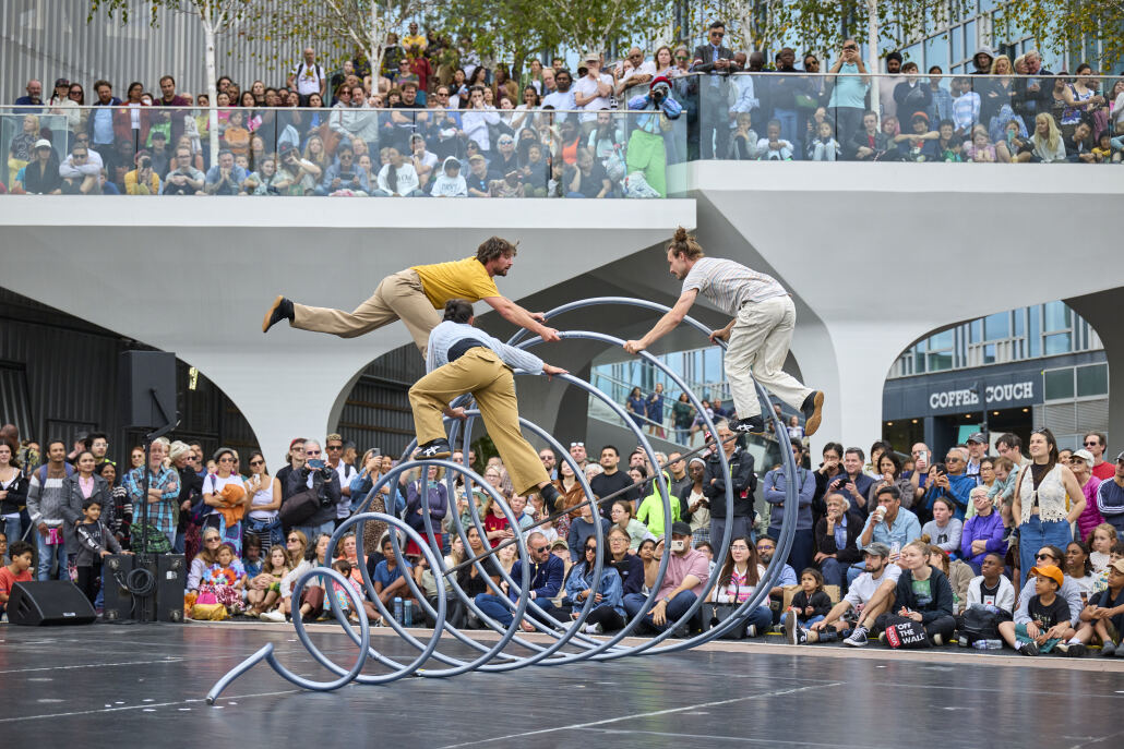 Acrobats balancing on a spring