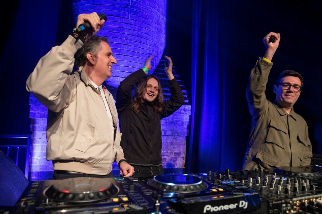 Steve Rotheram and Jamie Webster clapping to the music