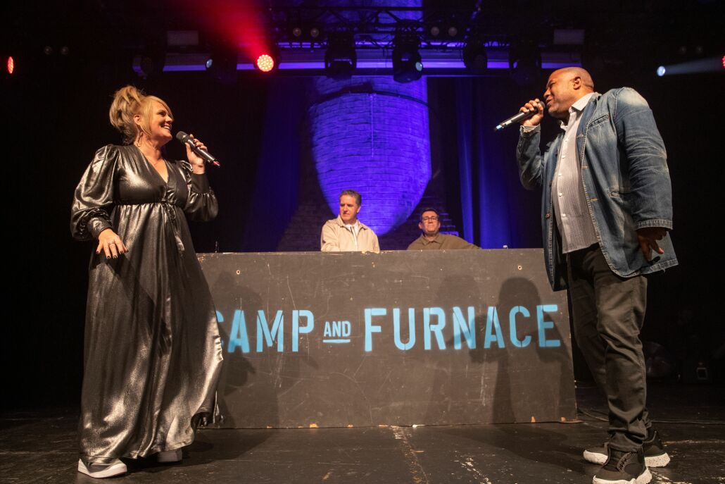 Sally Lindsay and John Barnes facing each other on stage