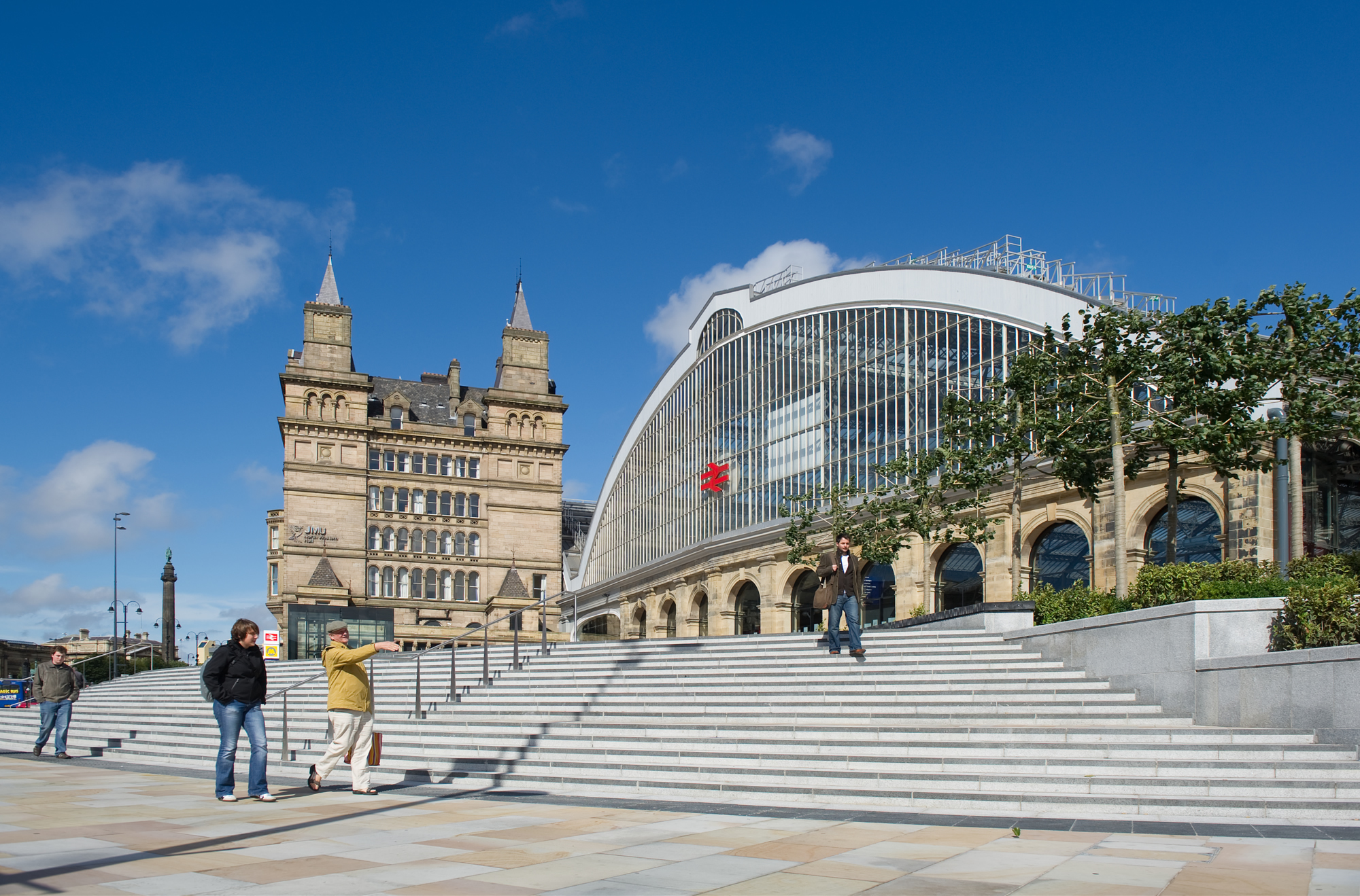 Pedestrians walk outside Lime Street Rail Station in central Liverpool