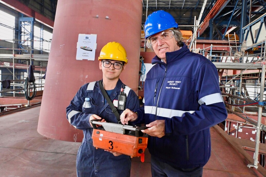 Mayor Steve Rotheram alongside Cammell Laird apprentice Jack Mercer as the lowering of the funnel gets underway on the Royal Daffodil