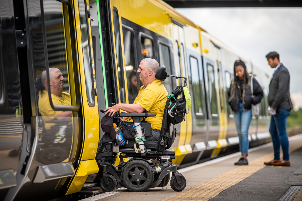A rail passenger in a wheelchair boarding a Class 777 Merseyrail train without assistance, using the sliding step