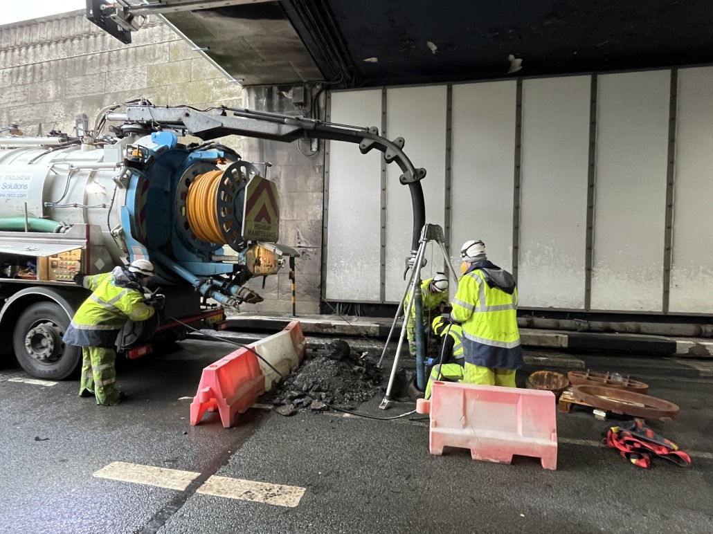 Workers and heavy machinery inside the Queensway Tunnel carrying out upgrade work