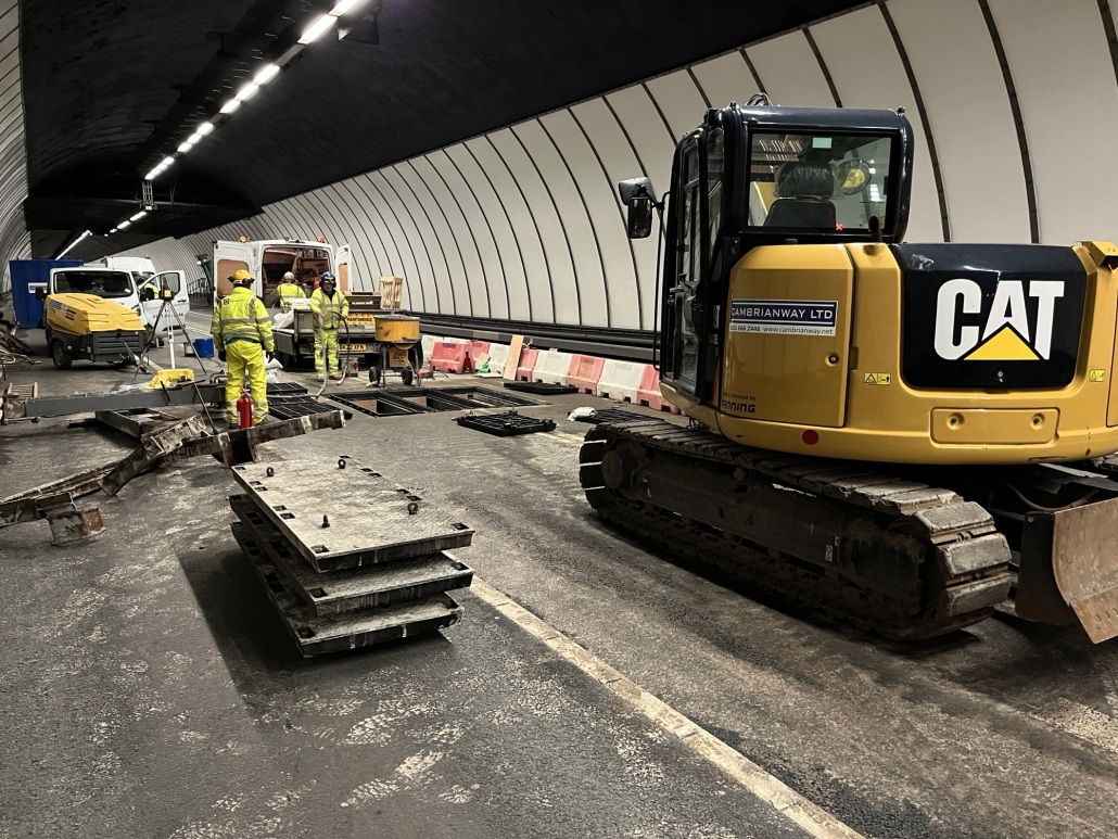 Workers and heavy machinery inside the Queensway Tunnel carrying out upgrade work