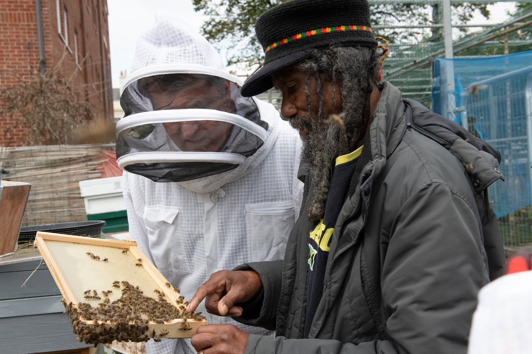 Mayor Steve Rotheram looks inside a beehive with beekeeper Barry.