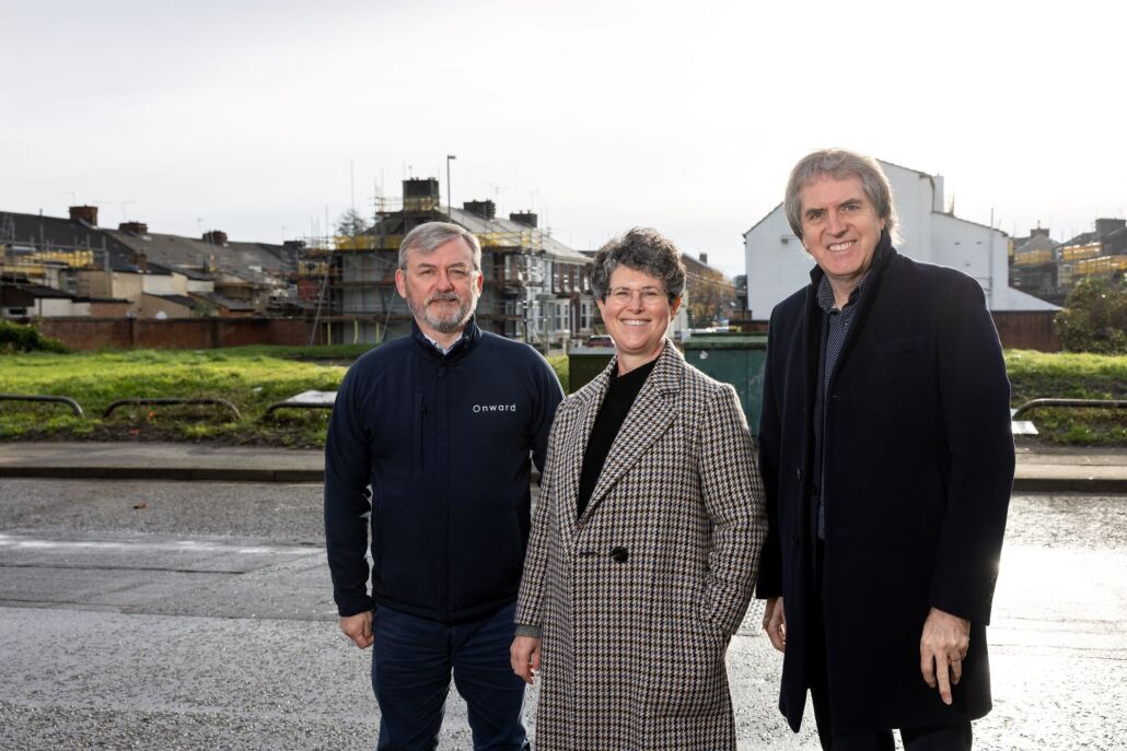 Sandy Livingstone, Bronwen Rapley and Mayor Steve Rotheram in front of terraced housing in Liverpool