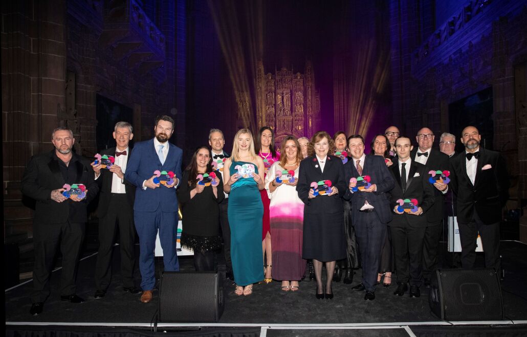 Tourism Award winners standing on the stage with their trophies