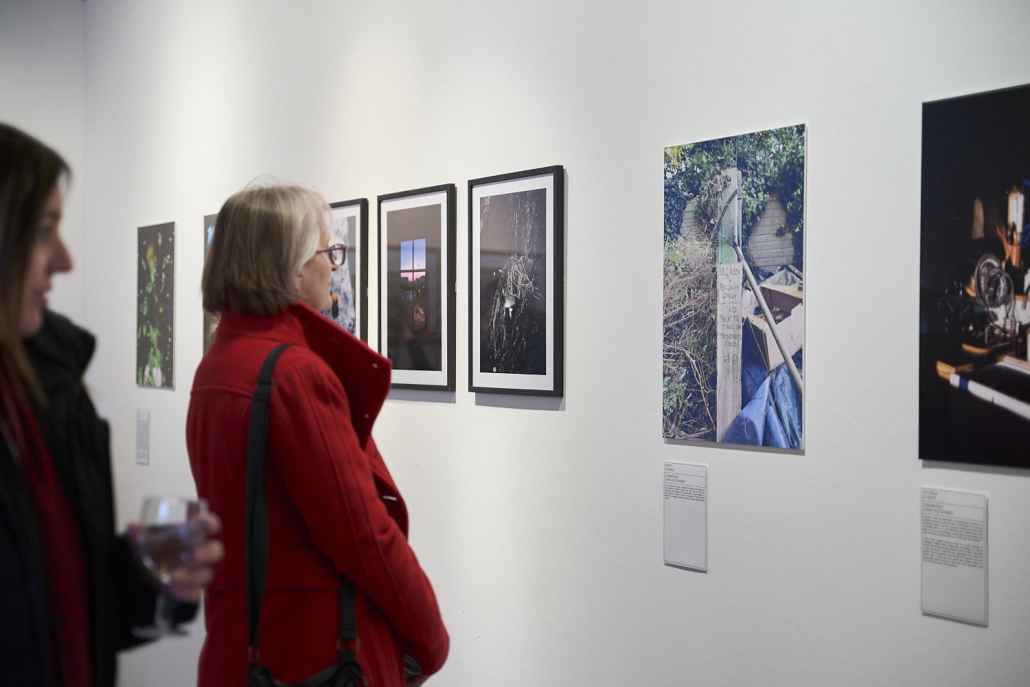 A woman looking at photos in a gallery